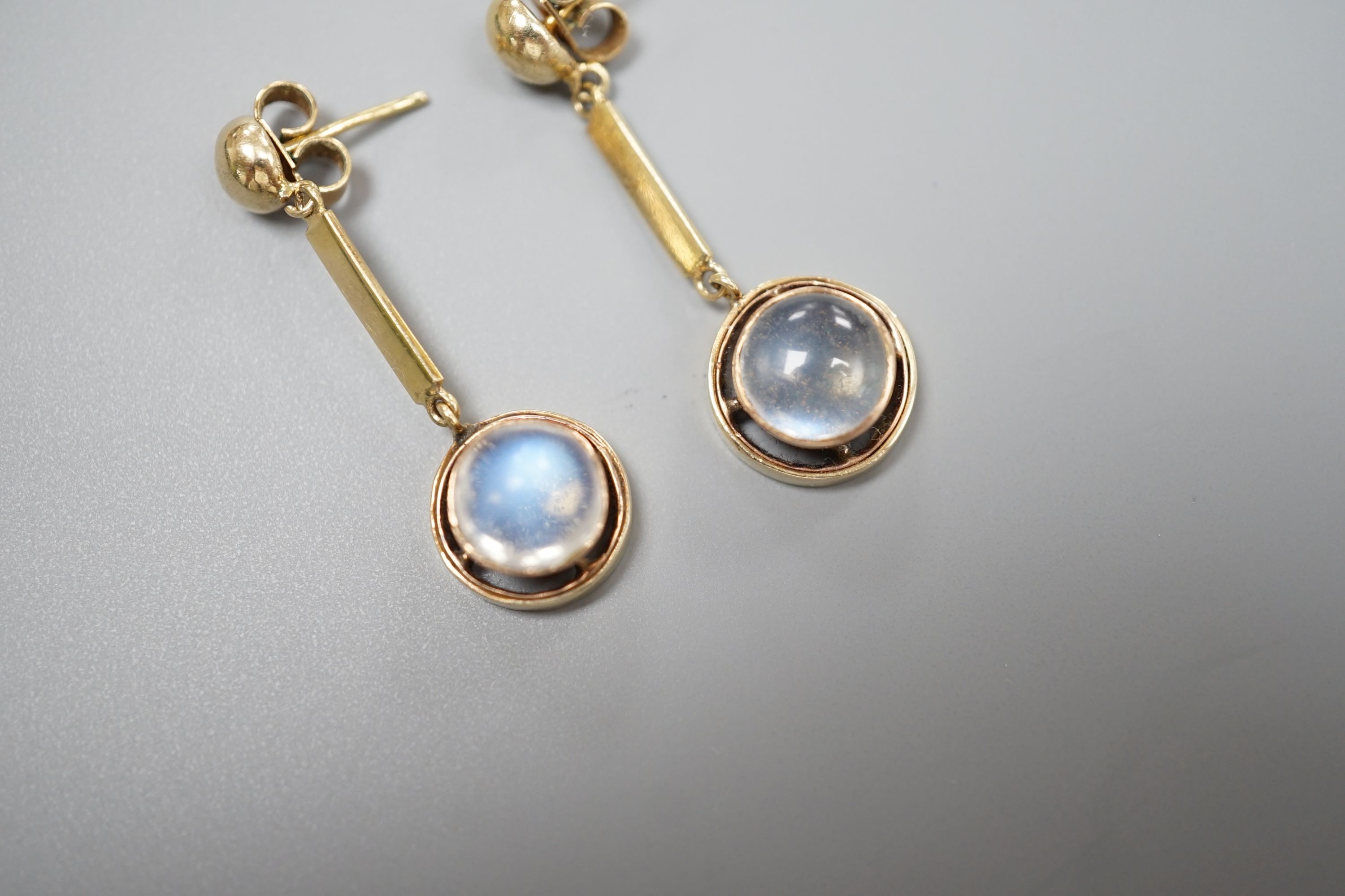 A pair of yellow metal and cabochon moonstone set drop earrings, 31mm, gross weight 4.8 grams.